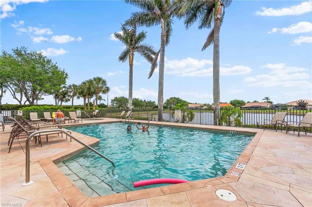 6417 Legacy Circle, Unit 1504 Naples, FL 34113 - Photo 42 of 49 a view of swimming pool with a table and chairs