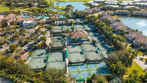 an aerial view of residential houses with outdoor space and lake view