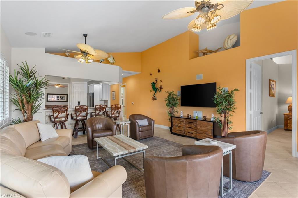 6417 Legacy Circle, Unit 1504 Naples, FL 34113 - Photo 6 of 49 a living room with furniture and a flat screen tv