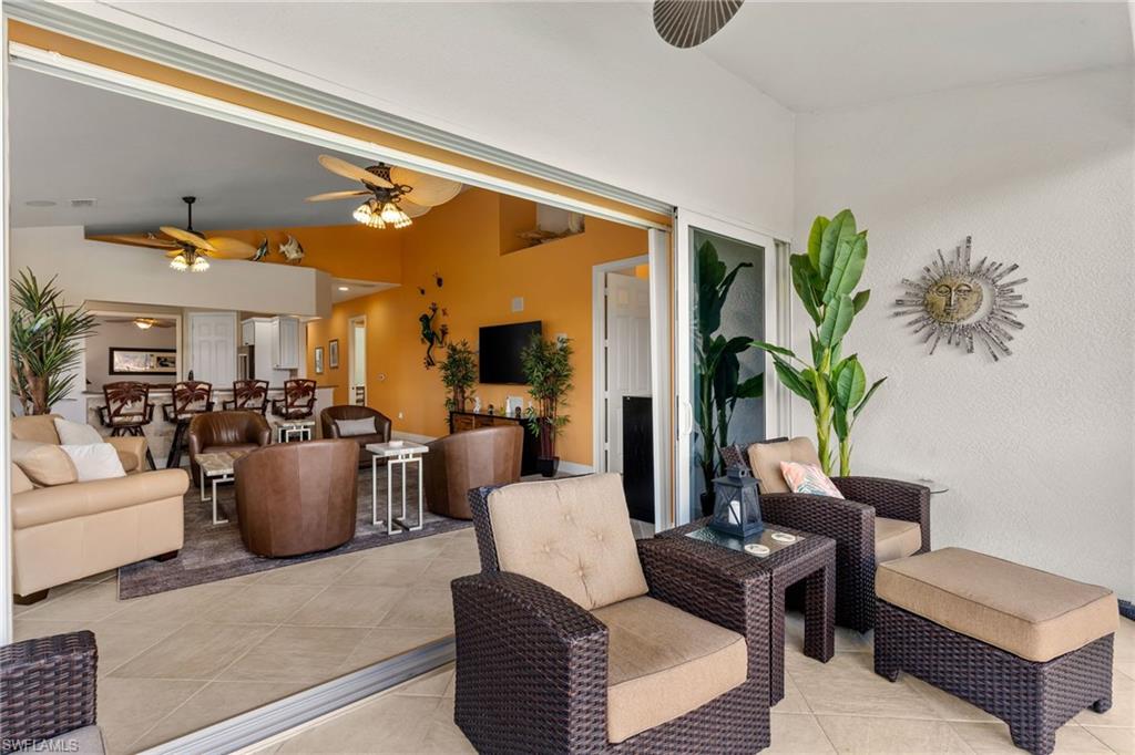 6417 Legacy Circle, Unit 1504 Naples, FL 34113 - Photo 9 of 49 a living room with furniture and a potted plant
