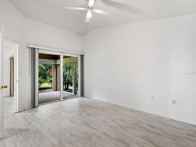 a view of a big room with wooden floor and windows