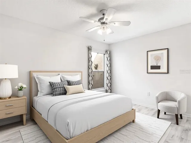 a bedroom with bed and a chandelier