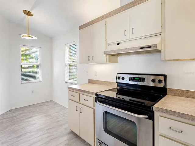a kitchen with a stove and a microwave