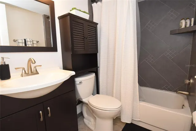a bathroom with a sink a toilet and bathtub