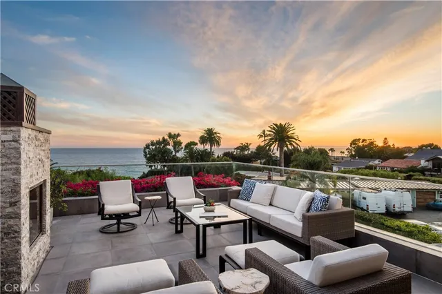 a roof deck with couches and potted plants