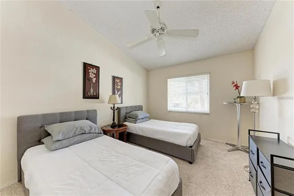 a bedroom with two beds and a window