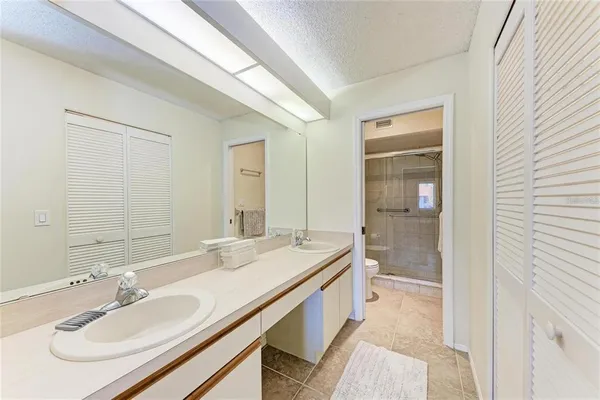 a spacious bathroom with a double vanity sink mirror and double