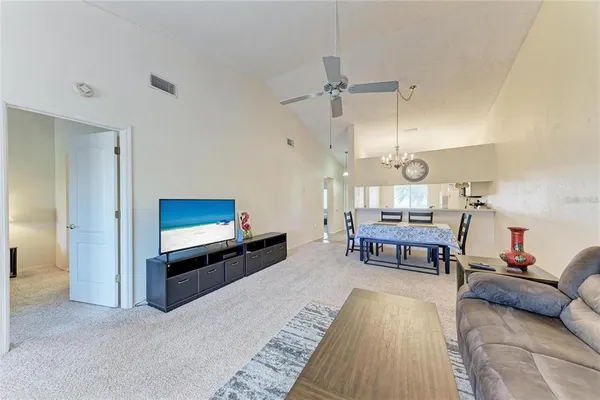 a living room with furniture a dining table and a wooden floor