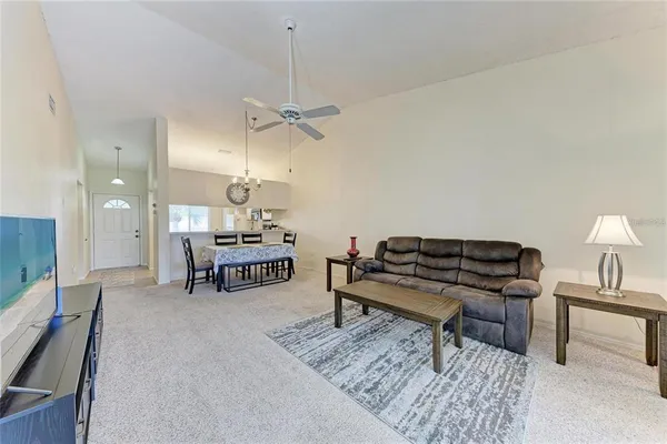a living room with furniture and a piano