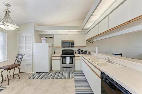 a kitchen that has a sink and a stove top oven