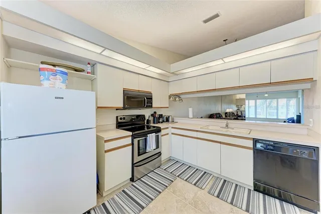 a kitchen with stainless steel appliances a refrigerator sink and stove