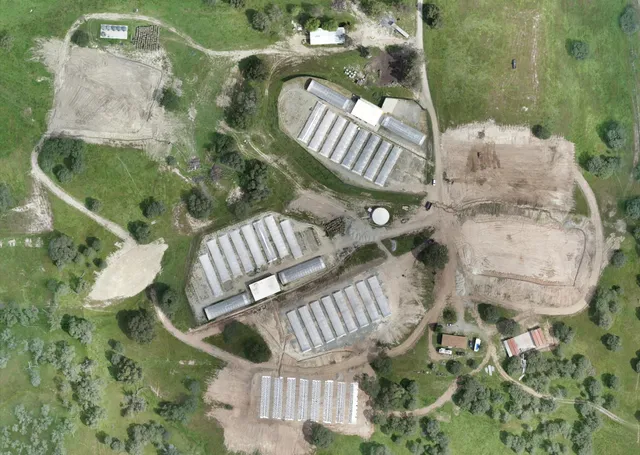 a view of a field with an ocean view