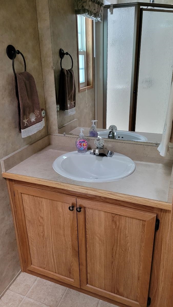 561 Corsons Tavern Road Ocean View, NJ 08230 - Photo 16 of 31 a bathroom with a sink and a mirror