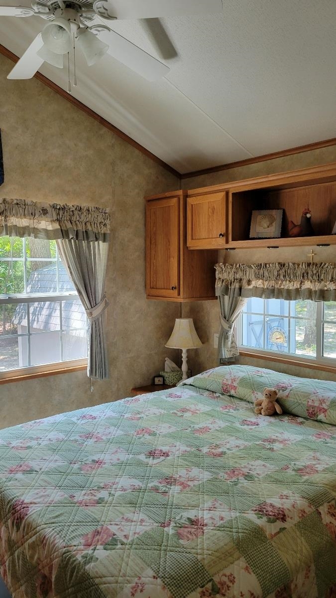 561 Corsons Tavern Road Ocean View, NJ 08230 - Photo 19 of 31 a bedroom with a bed and a dresser with floor