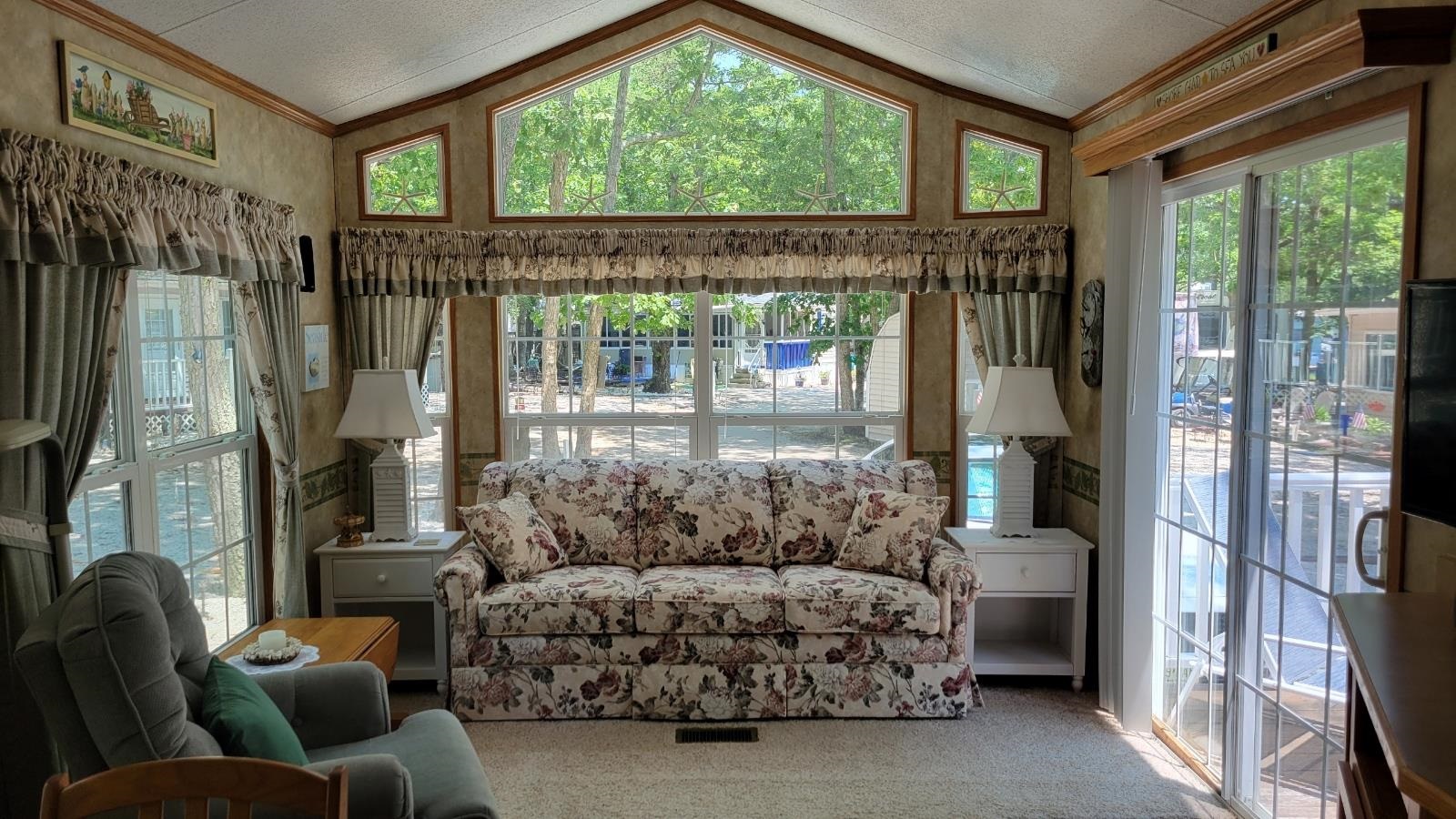 561 Corsons Tavern Road Ocean View, NJ 08230 - Photo 8 of 31 a living room with furniture and a floor to ceiling window