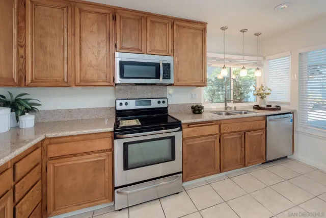 a kitchen with a sink stove and microwave