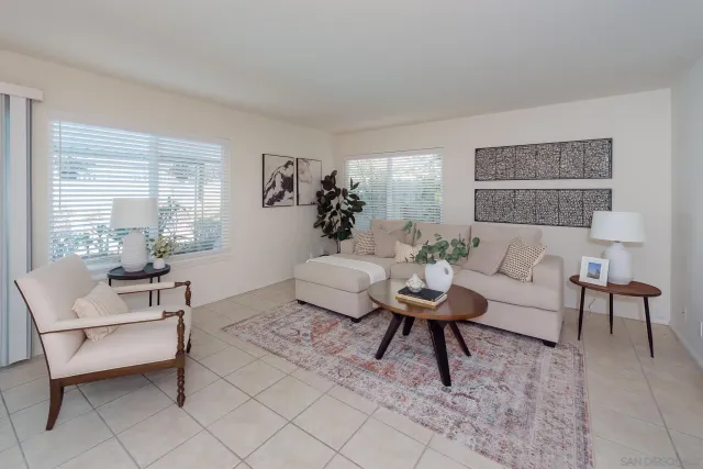 a living room with furniture and a potted plant