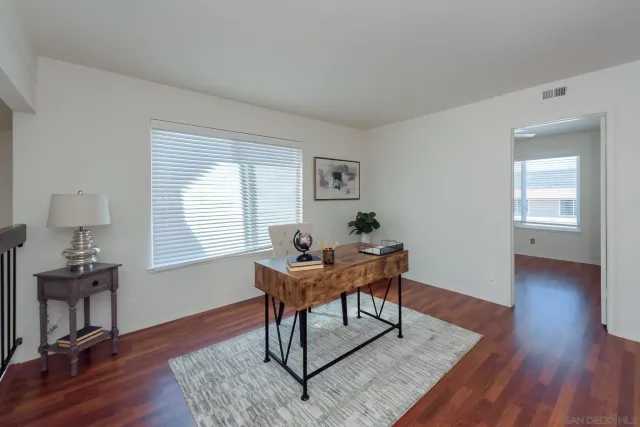 a workspace with furniture window and wooden floor