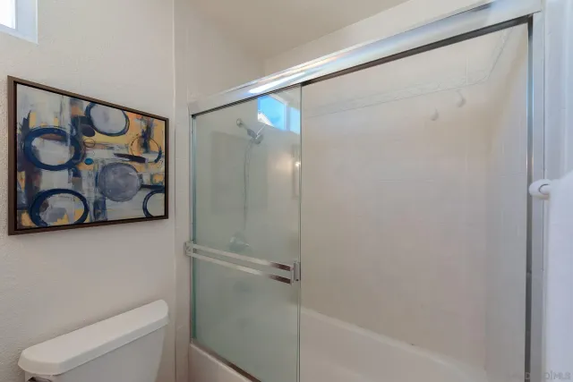 a bathroom with a shower and toilet