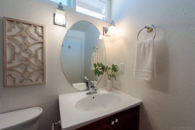 a bathroom with a sink vanity and toilet