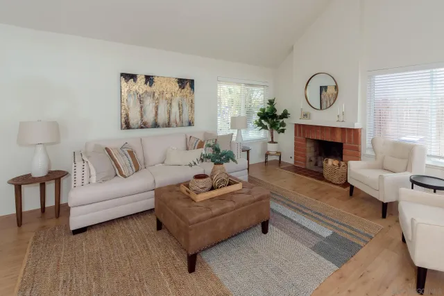a living room with furniture and a fireplace