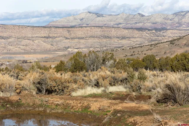 a room with water heater and a wooden floor