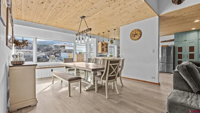 a kitchen with stainless steel appliances granite countertop a refrigerator a sink and a stove