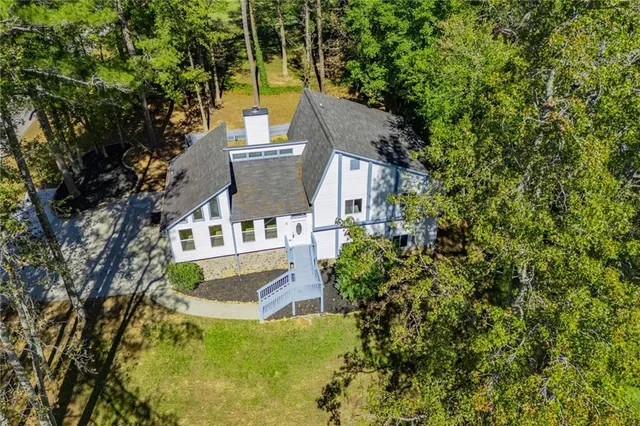 a view of a house with a yard and sitting area