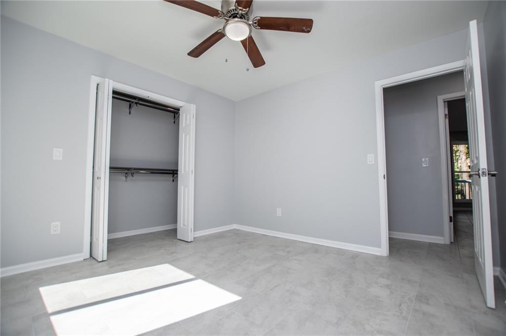 1039 Monticello Drive Villa Rica, GA 30180 - Photo 39 of 96 an empty room with closet and a chandelier fan