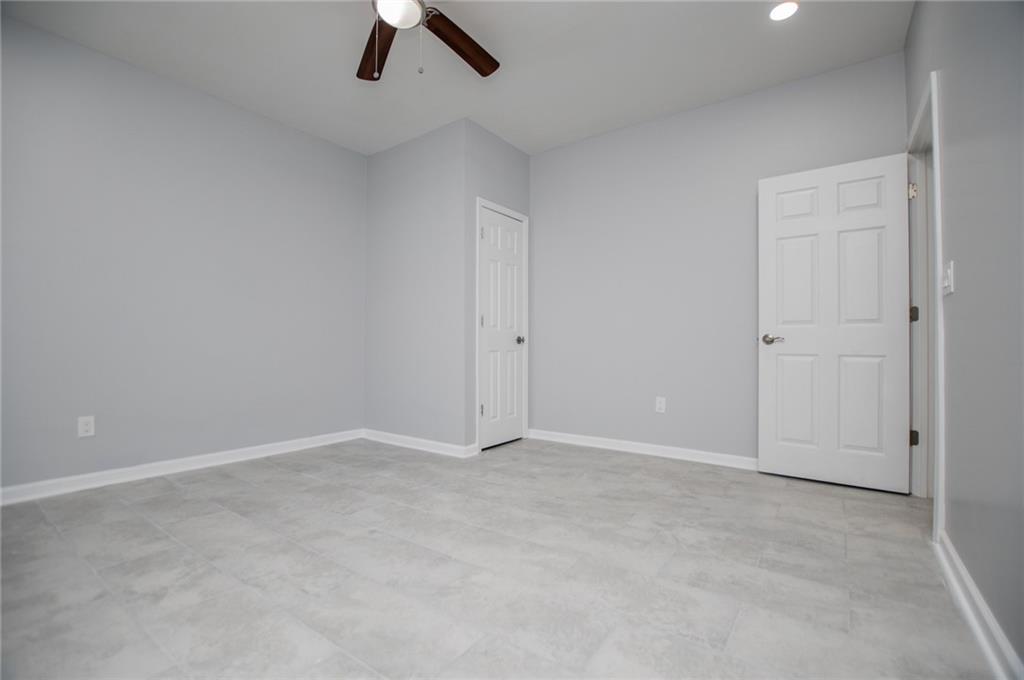 1039 Monticello Drive Villa Rica, GA 30180 - Photo 50 of 96 an empty room with view of ceiling fan