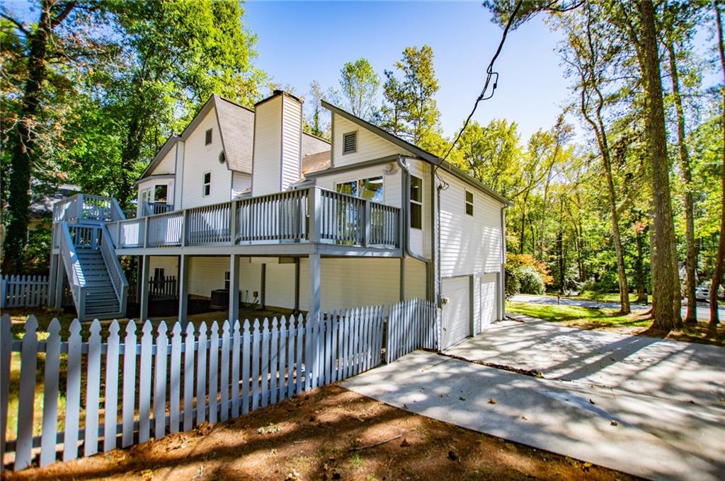 1039 Monticello Drive Villa Rica, GA 30180 - Photo 5 of 96 a view of a house with a small yard and wooden fence