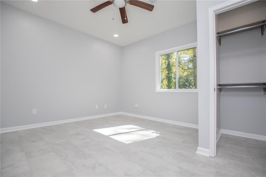 1039 Monticello Drive Villa Rica, GA 30180 - Photo 51 of 96 an empty room with ceiling fan and window