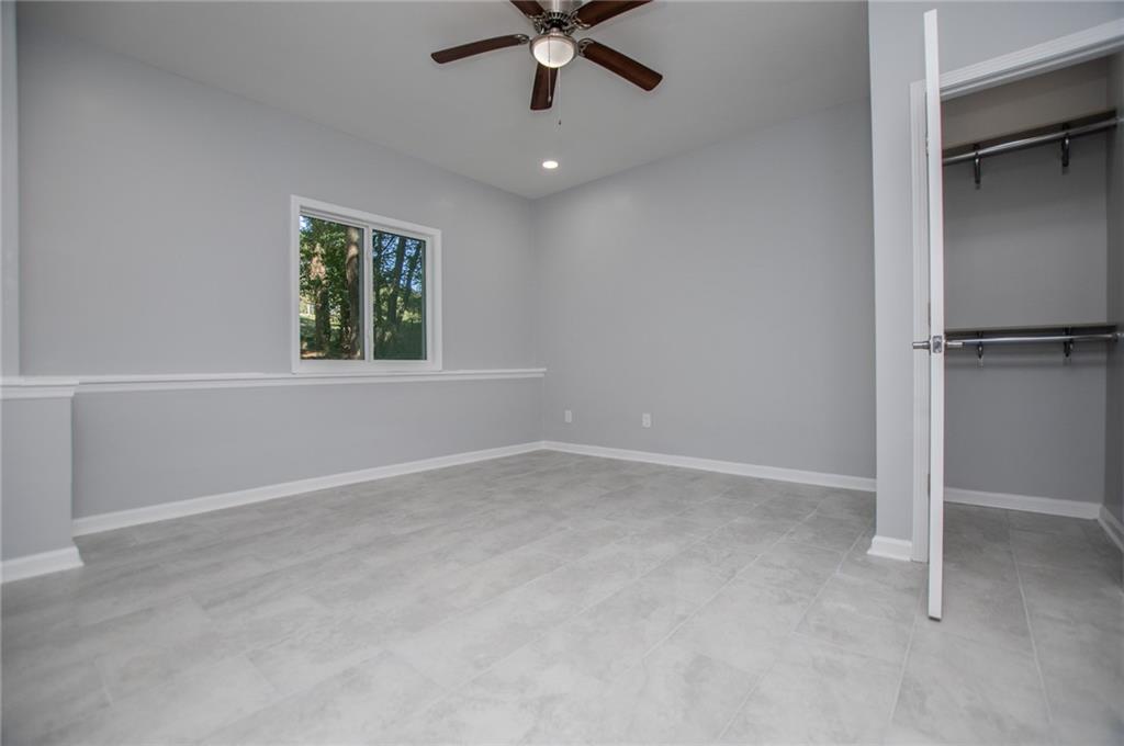 1039 Monticello Drive Villa Rica, GA 30180 - Photo 52 of 96 an empty room with window and a ceiling fan