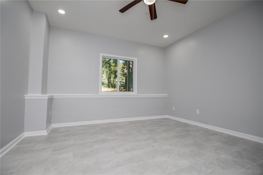 1039 Monticello Drive Villa Rica, GA 30180 - Photo 57 of 96 an empty room with ceiling fan and window
