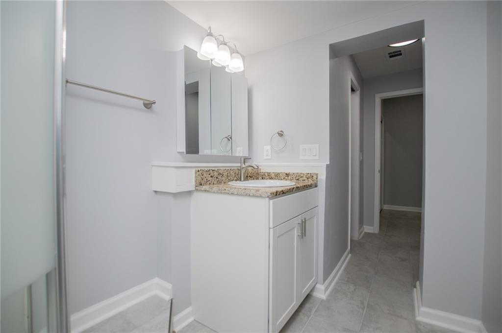 1039 Monticello Drive Villa Rica, GA 30180 - Photo 59 of 96 a bathroom with a sink a vanity and a mirror
