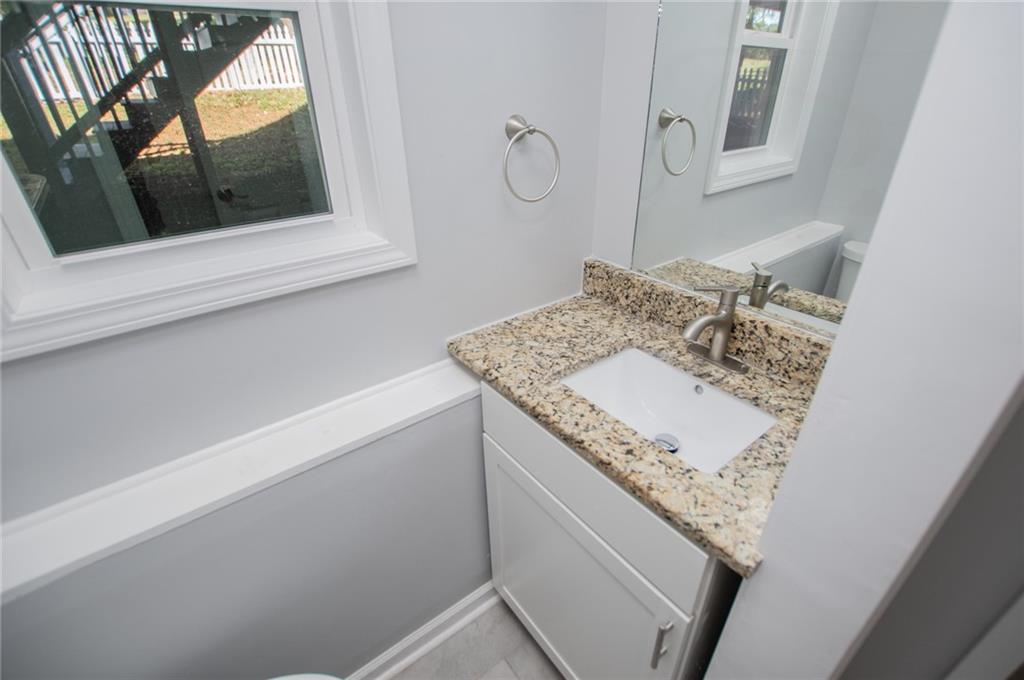 1039 Monticello Drive Villa Rica, GA 30180 - Photo 61 of 96 a bathroom with a sink and a mirror