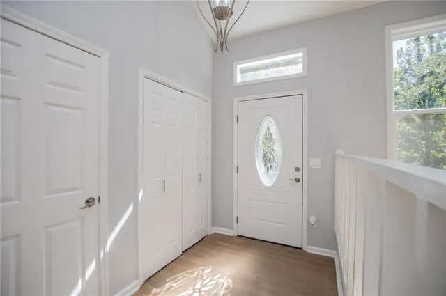 a view of a kitchen with a stove wooden cabinets and a large window