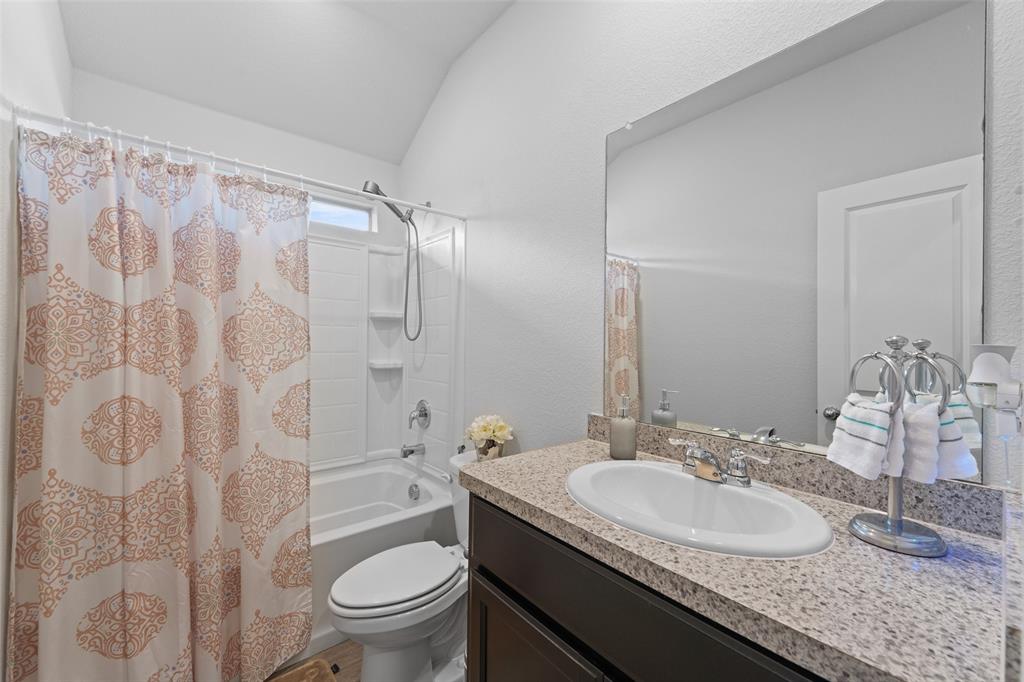 9020 Ridgeriver Way Fort Worth, TX 76131 - Photo 23 of 26 a bathroom with a granite countertop sink a toilet and a mirror
