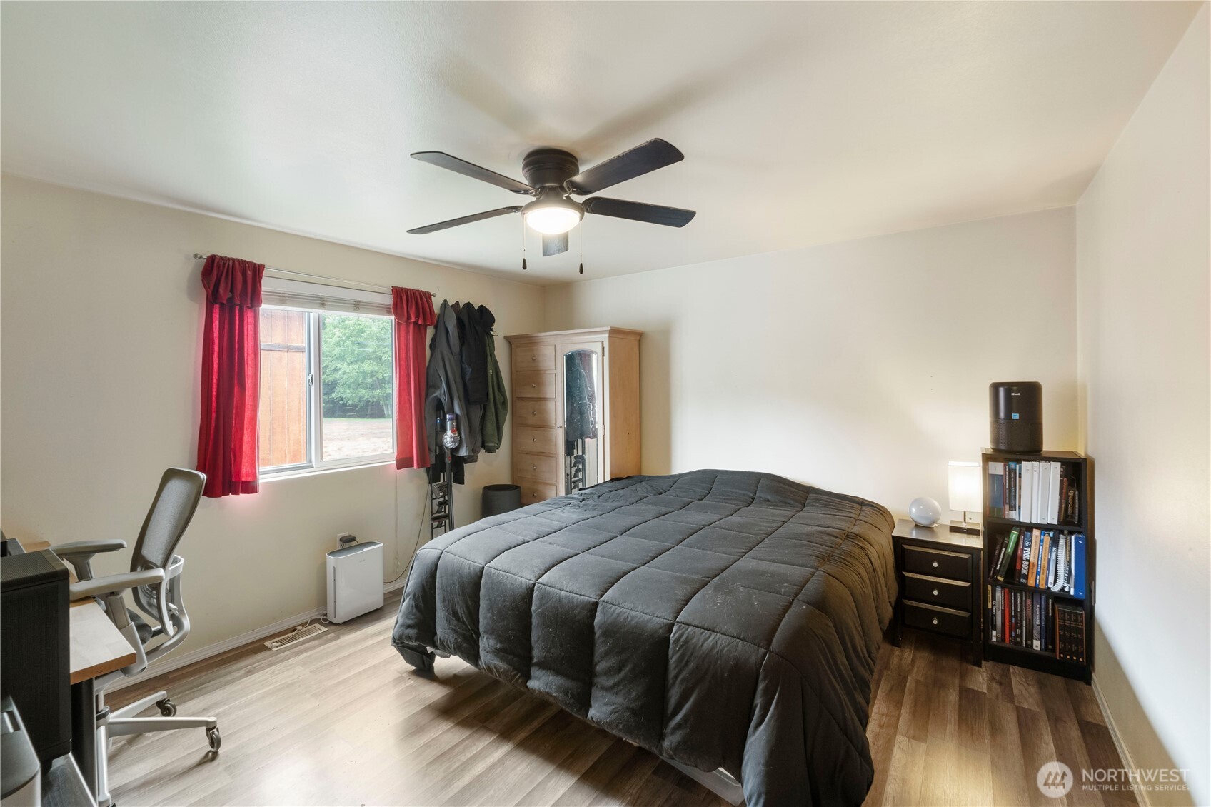 2219 Key Peninsula Highway Southwest Lakebay, WA 98349 - Photo 14 of 40 a bedroom with a bed and a chandelier