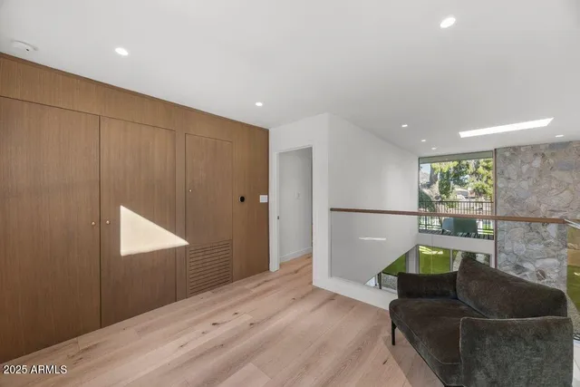 a hallway with wooden floor and furniture
