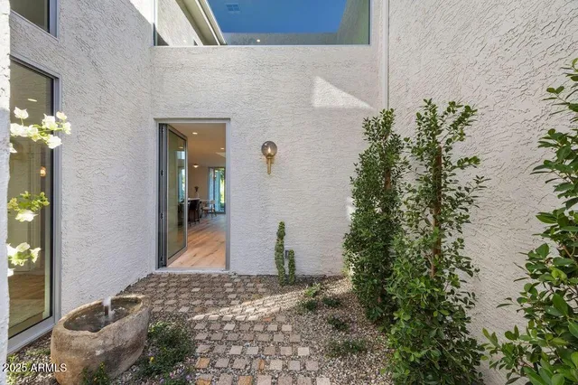a bedroom with a bed and a potted plant
