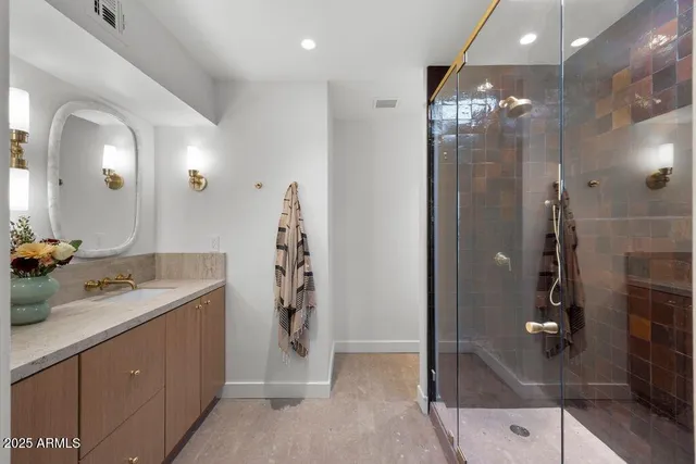 a bathroom with a shower sink and mirror