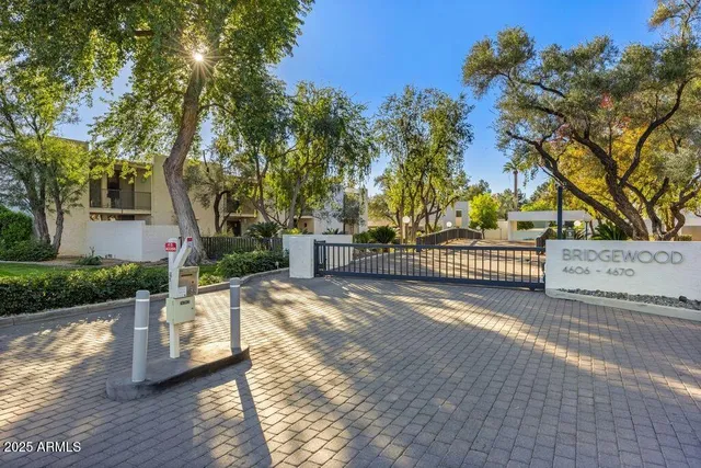 a view of a pathway with a wrought fence