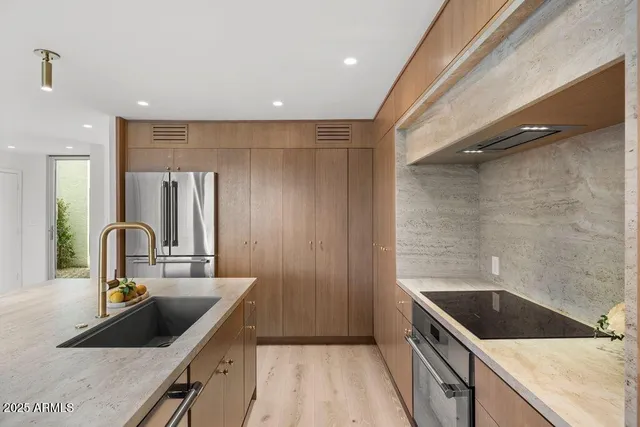a kitchen with a sink and a refrigerator