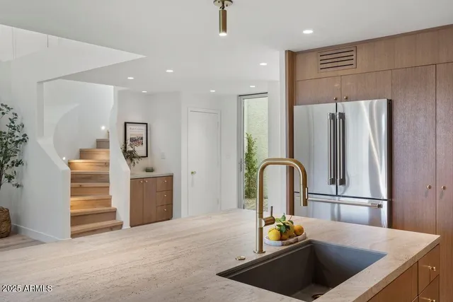 a kitchen with refrigerator and tub