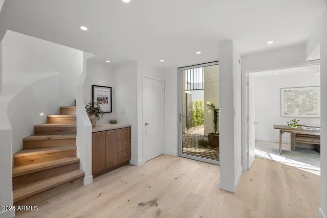 a view of entryway and hall with wooden floor