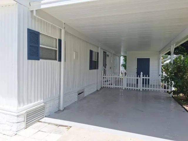 a view of a porch with wooden floor and fence