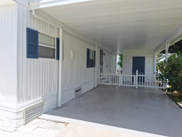 886 Pecan Circle Sebastian, FL 32976 - Photo 2 of 17 a view of a porch with wooden floor and fence