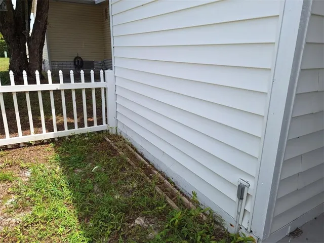 a view of a house with a wooden fence