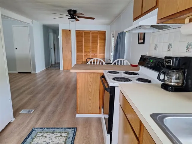 a kitchen with a stove a sink and a refrigerator